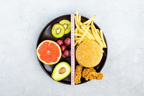 burger fries and fruits on a plate